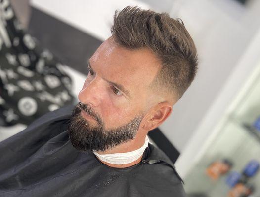 A mid skin fade and beard trim