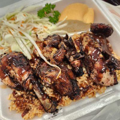 Small jerk chicken served with rice and peas (aka beans) and coleslaw. SO GOOD!