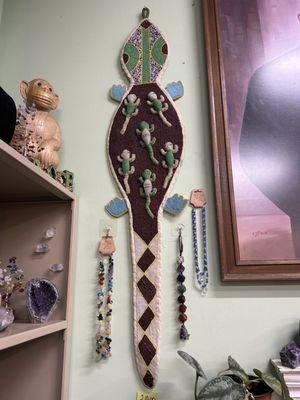 Hand beaded reptile next to sons lovely handmade jewelry