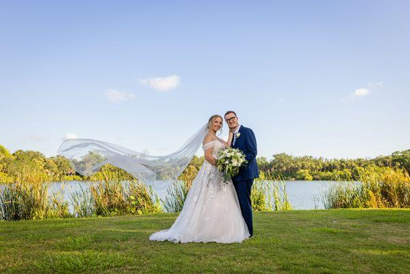 Beautiful shot of the couple by the water.