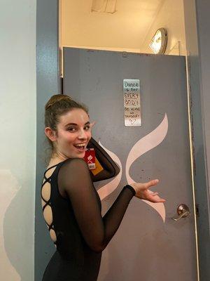 Dani in a Capezio leotard with a great sign