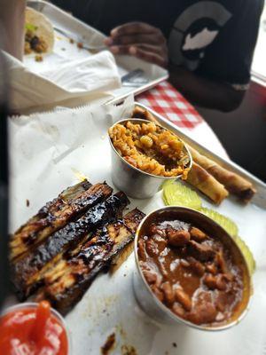 Pork belly, baked beans and spicy jambalaya and Asian egg rolls