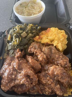 Smothered pork chops over yellow rice, Mac and cheese, collard greens, extra side of cabbage.