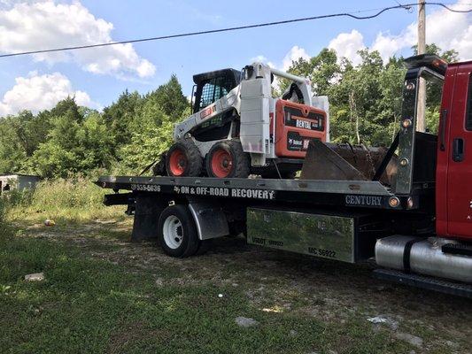 Deckers Towing & Recovery  Hauling bobcat equipment for customers