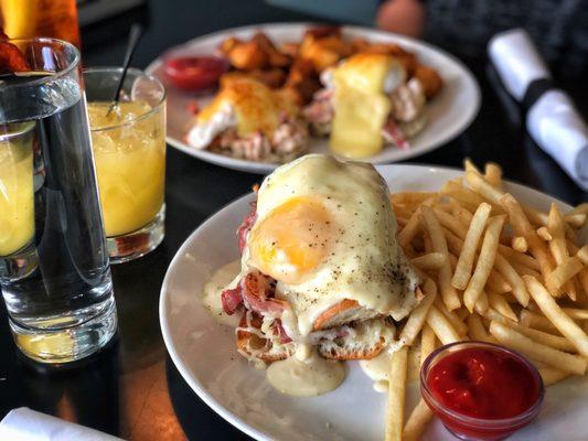 Sunday brunch Croque Madame with fries and Lobster Benedict with breakfast potatoes.