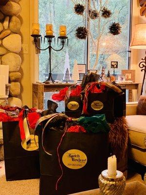 Wrapped gifts from Ranch Revived.   Hyde Flasks, Leather Pillows, Candles, and more.