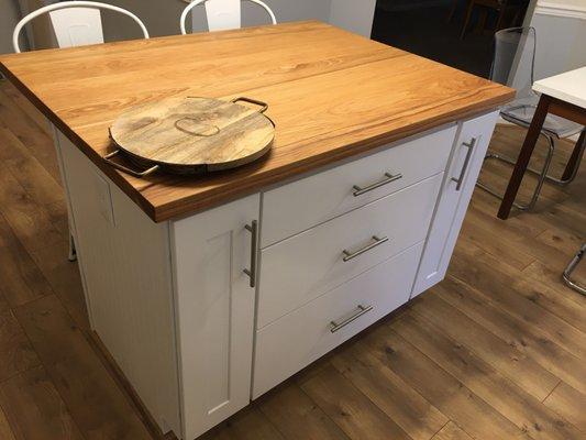 My butcher block island with drawers for pots and pans and cabinets for backing sheets and cutting boards.