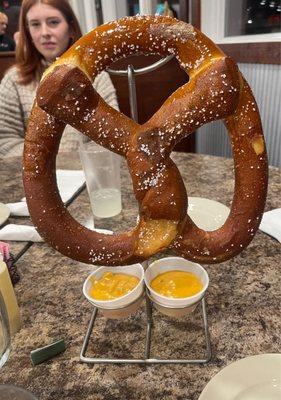 Giant pretzel appetizer with spicy cheese