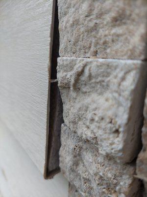 Vinyl siding left open to elements and insects.