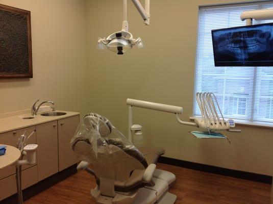 Treatment room. New equipment, large screen monitors, and comfortable chairs at the office of Knoxville dentist Robert M. Kelso, DDS