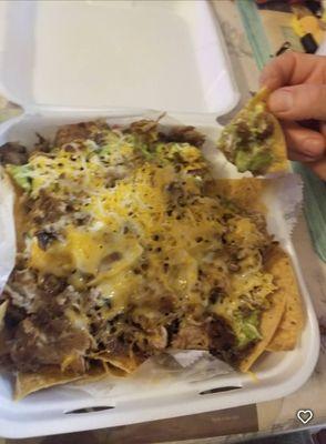 Super Nachos, choice of meat (Asada, pollo, carnitas, or pastor) cheese, guacamole, sour cream pico de gallo, and beans.