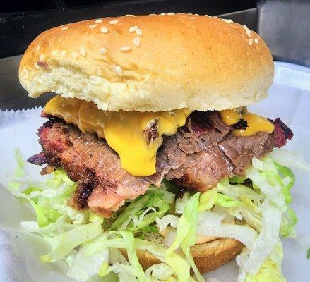 The Brisket Mac Daddy! 1/3 lb. Smoked Brisket, Special Sauce, Lettuce, Cheese, Pickles, and Onions on a Sesame Seed Bun