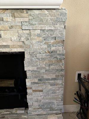 This is how they " remodeled " my fireplace. Gaps, stones sticking out, short mantel.