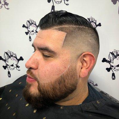 Haircut description: Mid bald fade #2 guard combover with side part and beard line up.