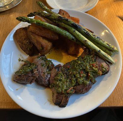 Steak frites with potato wedges and asparagus. The steak frites melt in your mouth. Very tender and seasoned to perfection.