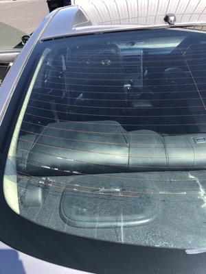 Tinting removed by another company - scraped off defrost lines.