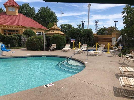 Pool area with closed hot tub