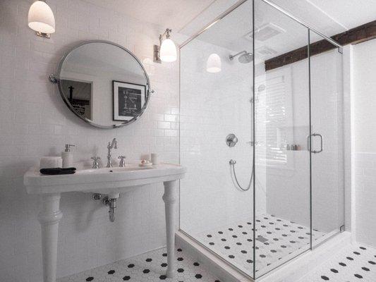 Sparkling tile and an oversized steam shower. This is in the Katharine Hepburn room. See more at jamespharmacybnb.com