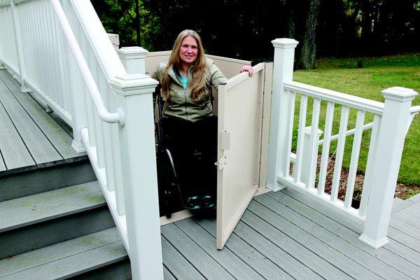 Woman exiting wheelchair lift onto deck in home in CT