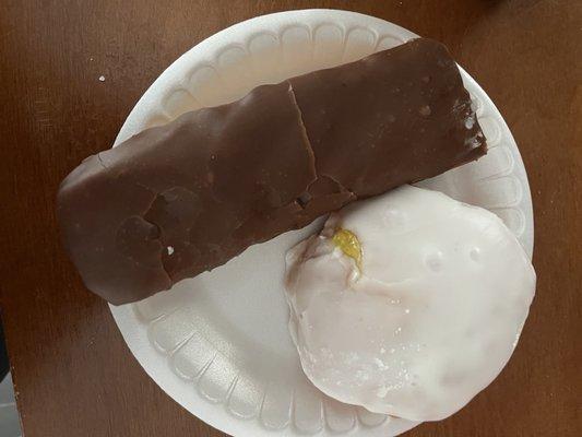 Lemon filled with white frosting and chocolate long John with cream in middle