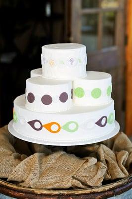 Fondant medalions in plum, orange, & lime green.