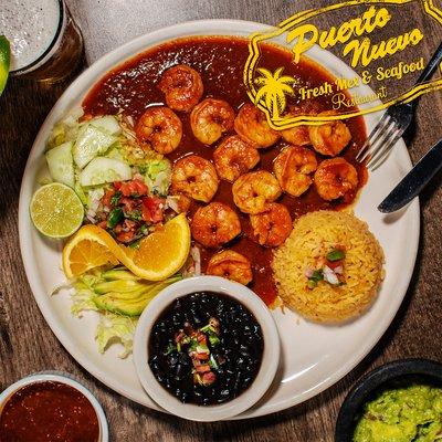 Camarones a la Diabla Shrimp grilled in a hot and spicy sauce. Served black beans with rice and a salad