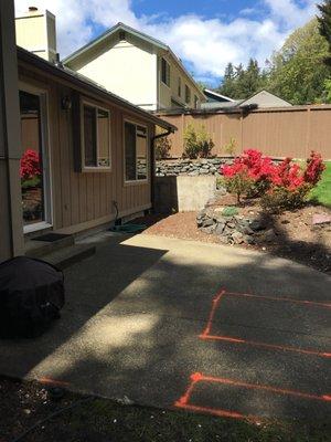 Existing wall was incorporated into new retaining wall. Rockery was demolished.