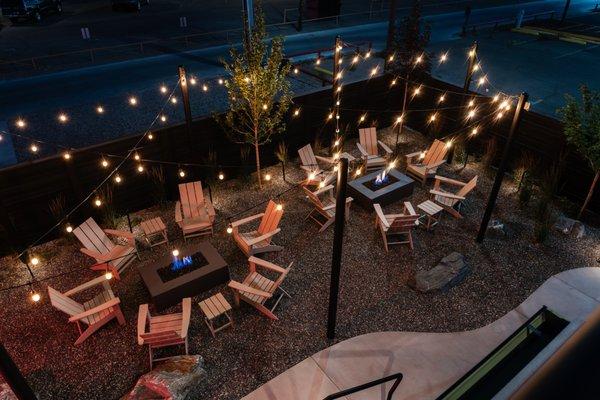 Outdoor patio seating for hotel guests, equipped with fire pits.