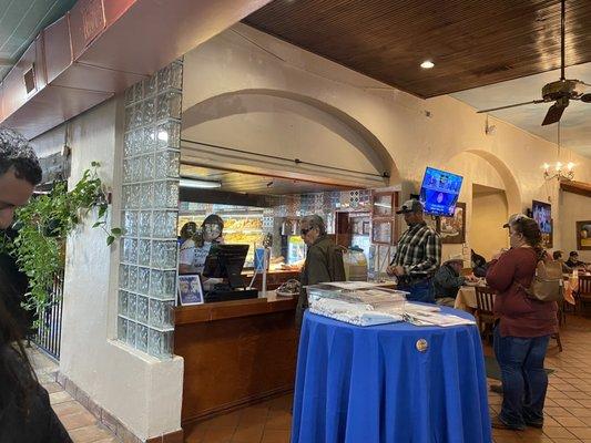 Pay at the cashier. View of the bakery in the background.