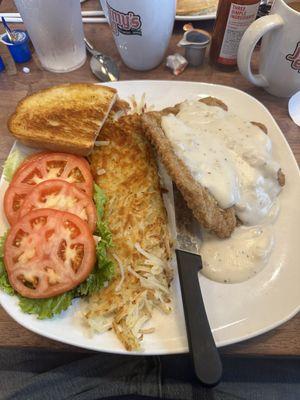 Country fried steak with tomatoes slices