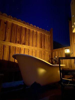 Moonlit bathtub with instant water heater.