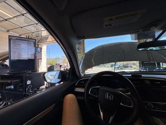 Just a photo of me, sitting in the car with the screen and what's being done in the cost on the left side