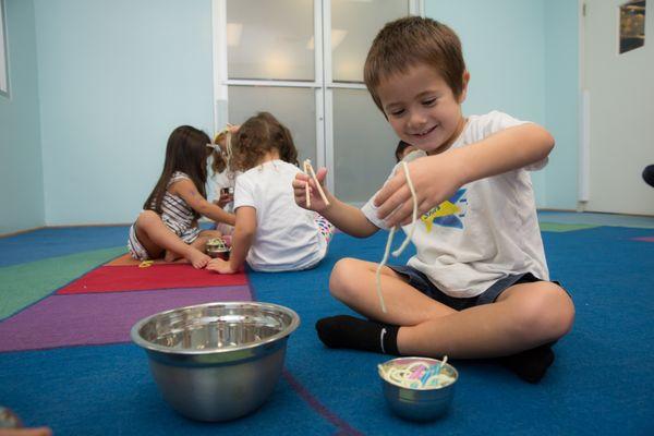 Developing fine motor skills early aids in coordination and learning. Kids practice this daily at our preschool through fun activities!