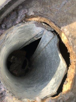 A roof view of a dryer vent that is not connected correctly.