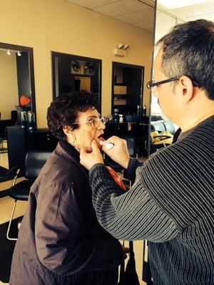 Frank the owner touching up his mothers lipstick.