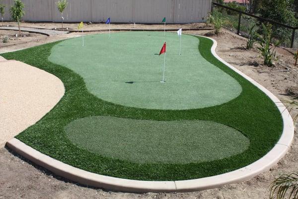 Concrete curb surrounding a putting green