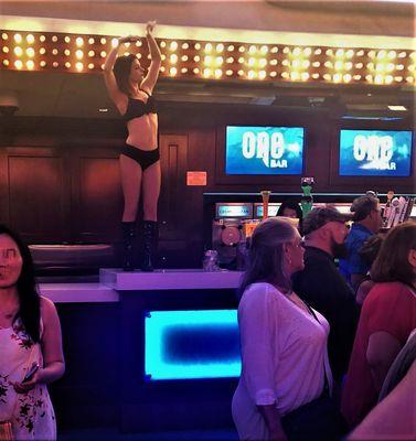 Go Go Dancer on Top of OneBar at Night