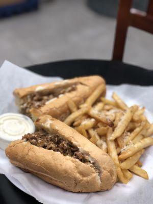 Cheesesteak with french fries (that has parmesan sprinkled on top)