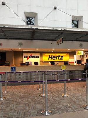 Front of Dollar/Hertz car rental desks