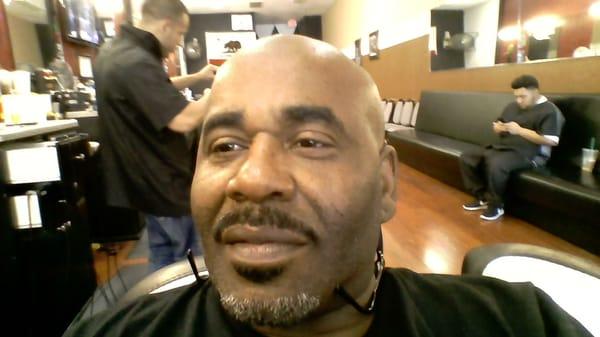 Theron Mims one of the barber's ,z been cutting hair for 18yrs  and also does straight razor shaves