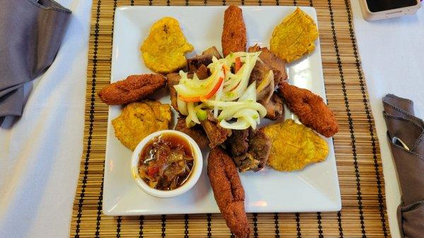 Appetizer Platter  Skewered griot with bell pepper and onion, okra, chiquetaille, and plantains