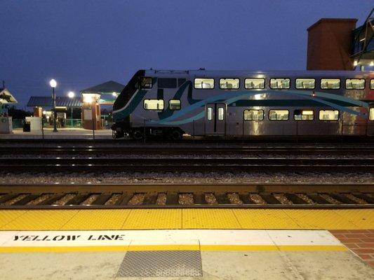 Early morning for first Metrolink train. Parked underneath a tree in the secure looking parking lot.