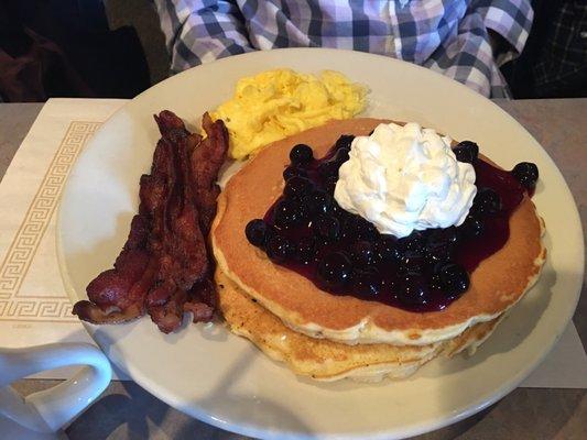 Blueberry pancakes, eggs and bacon.