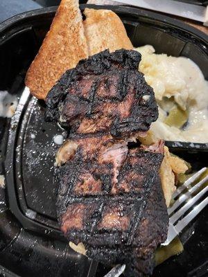 Burnt, small Ribeye Steak Dinner. NOT ribeye!