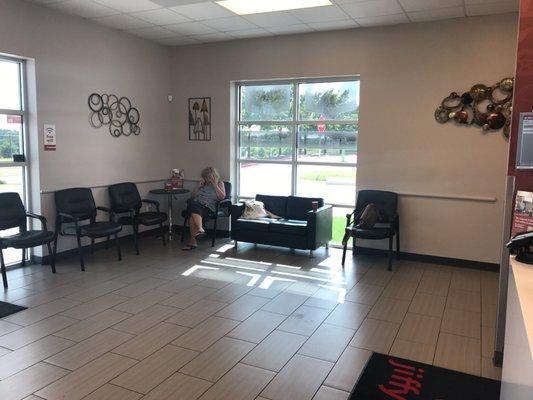 Clean, comfortable waiting area with TV and free WiFi access