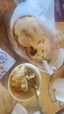 Toasted tortillas and marinated onions as an appetizer.