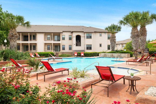 Swimming pool with lounge chairs at the Villas at Medical Center