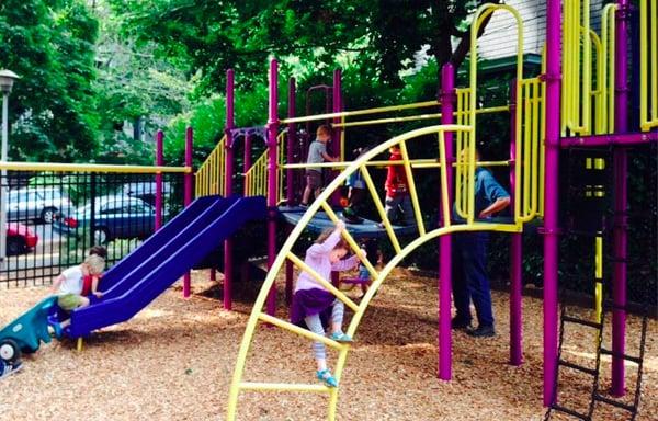 The kids (and a parent) enjoying some outside time on the play structure.