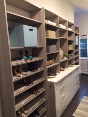 See 2 sections of shoes around sweater shelves with a dresser below, with drawers, a counter and a hamper on HGTV's Property Brothers