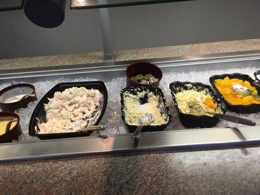 Seafood salad, cole slaw, potato salad, peaches and cottage cheese on salad bar